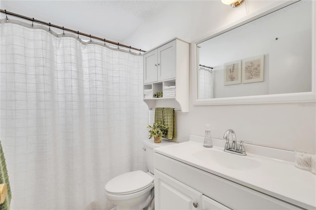 bathroom featuring a shower with curtain, vanity, toilet, and a textured ceiling