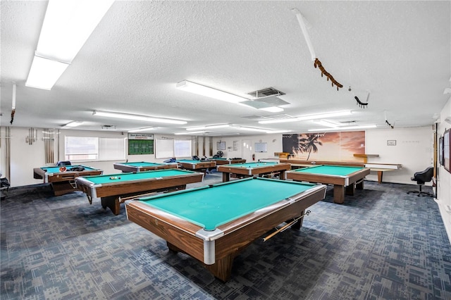 rec room with dark carpet, a textured ceiling, and pool table