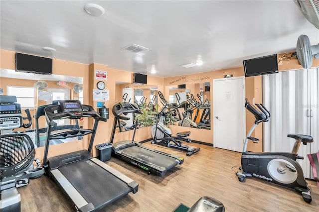 workout area with wood-type flooring