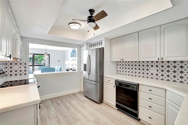 kitchen with stainless steel fridge, ceiling fan, white cabinets, black dishwasher, and tasteful backsplash