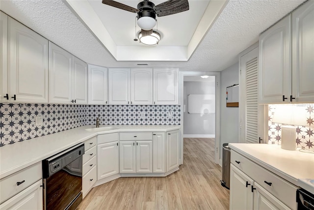 kitchen with ceiling fan, white cabinetry, dishwasher, and light wood-type flooring