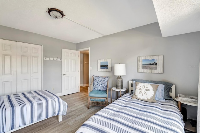 bedroom featuring a closet and light wood-type flooring