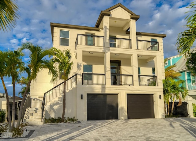 view of front of home featuring a balcony and a garage