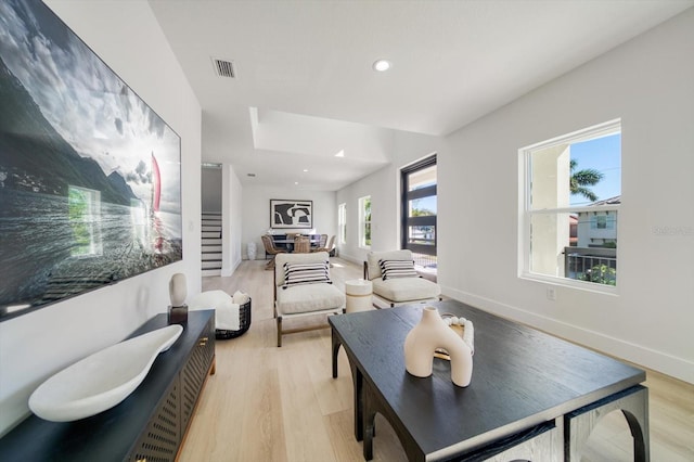 living room with plenty of natural light and light hardwood / wood-style flooring