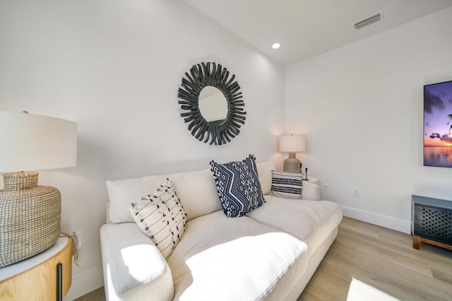 living room with lofted ceiling and light hardwood / wood-style floors