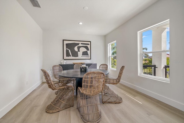 dining space with light hardwood / wood-style floors