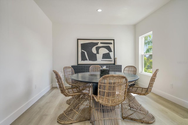 dining space with light hardwood / wood-style floors