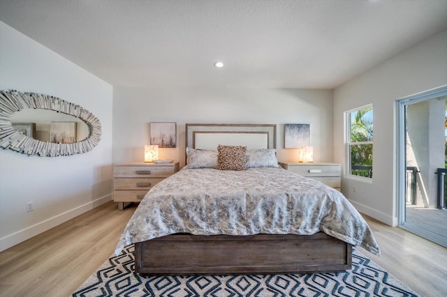 bedroom featuring access to exterior and light hardwood / wood-style flooring