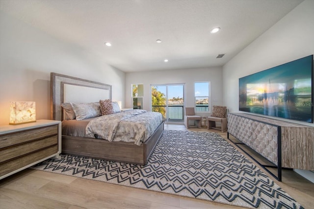 bedroom featuring access to outside and hardwood / wood-style flooring