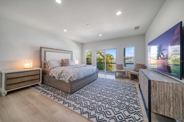 bedroom featuring light hardwood / wood-style floors and access to exterior