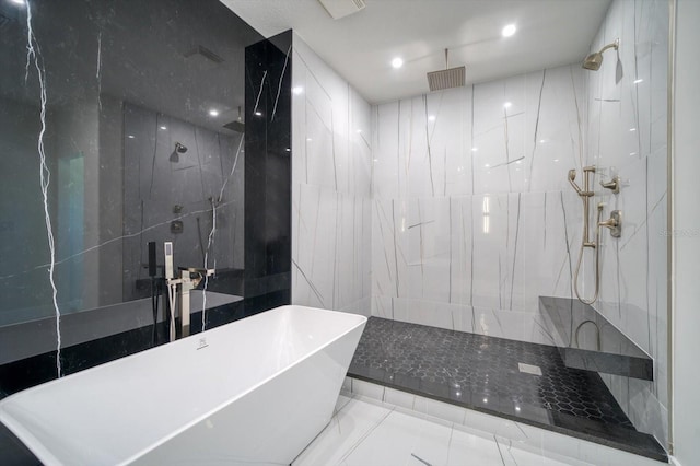 bathroom featuring tile floors, tile walls, and tiled shower