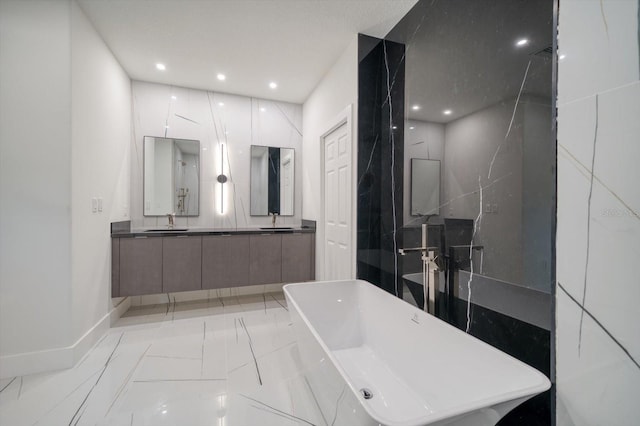 bathroom with tile walls, tile floors, dual vanity, and a washtub