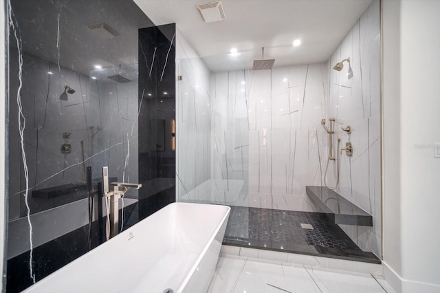 bathroom featuring tile floors and tiled shower