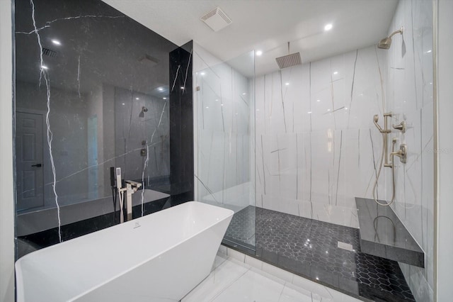 bathroom with tile floors and tiled shower