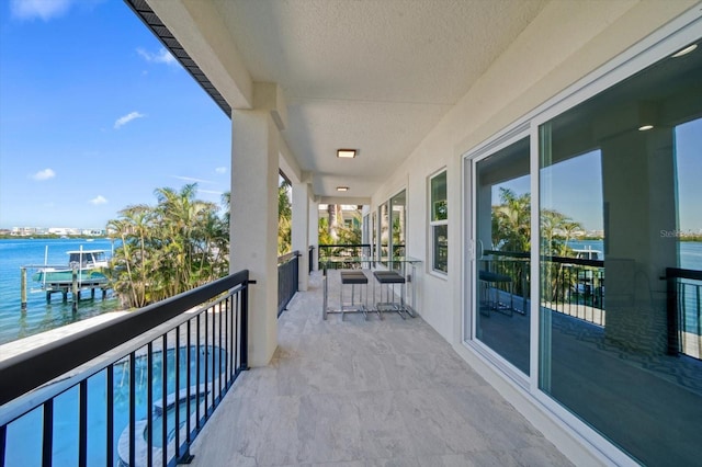 balcony featuring a water view