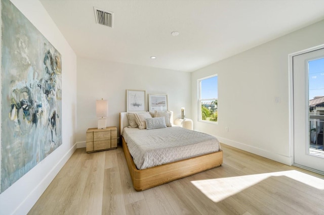 bedroom featuring access to outside and light hardwood / wood-style flooring