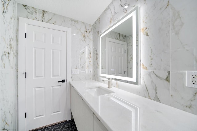 bathroom featuring tile walls, vanity with extensive cabinet space, and tile flooring