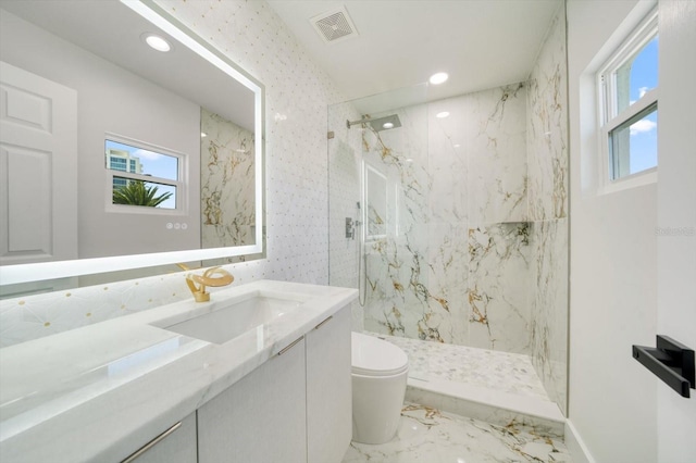 bathroom with toilet, tile flooring, vanity, and tiled shower