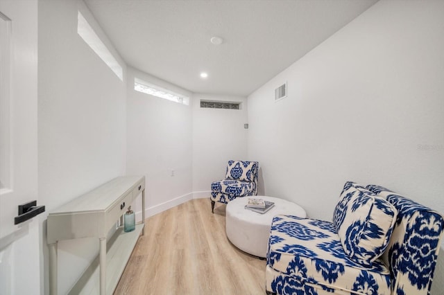 sitting room with light hardwood / wood-style floors