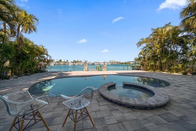 view of swimming pool featuring an in ground hot tub and a patio area