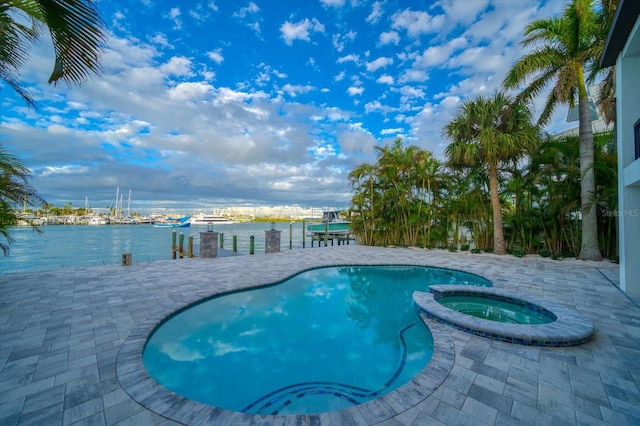 view of pool with an in ground hot tub