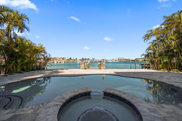 view of pool featuring an in ground hot tub and a water view