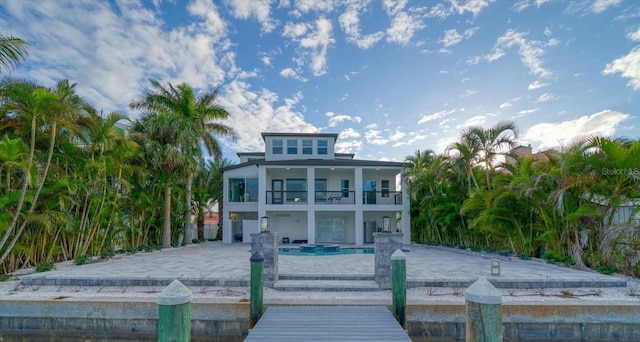 rear view of property with a balcony and a patio area