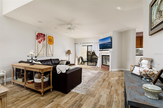 living room with light hardwood / wood-style floors and ceiling fan