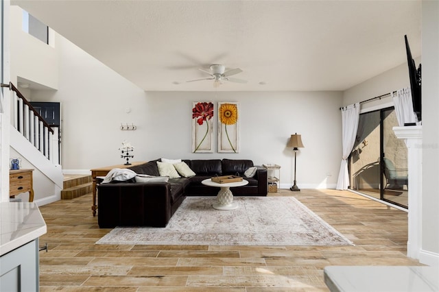 living room featuring ceiling fan and light hardwood / wood-style flooring