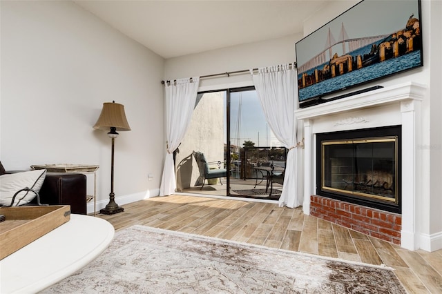 living room featuring light hardwood / wood-style flooring and a fireplace