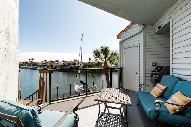 balcony featuring a water view and a grill