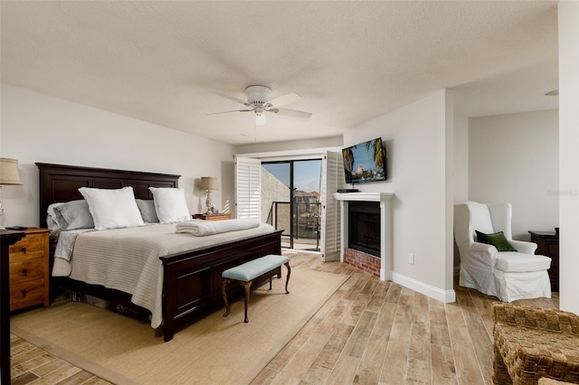 bedroom with access to outside, a textured ceiling, light hardwood / wood-style floors, and ceiling fan