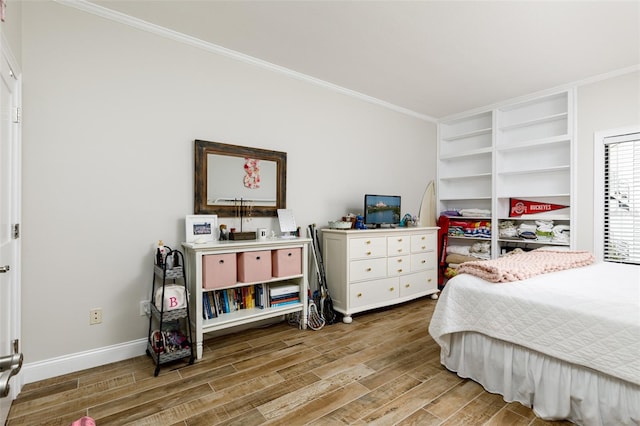 bedroom featuring hardwood / wood-style floors and crown molding