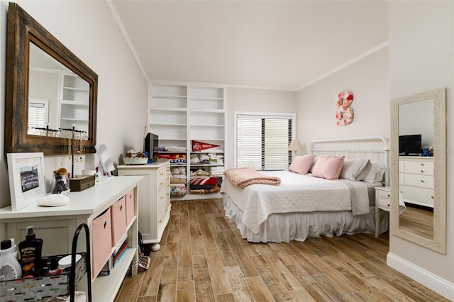 bedroom with crown molding and light hardwood / wood-style floors