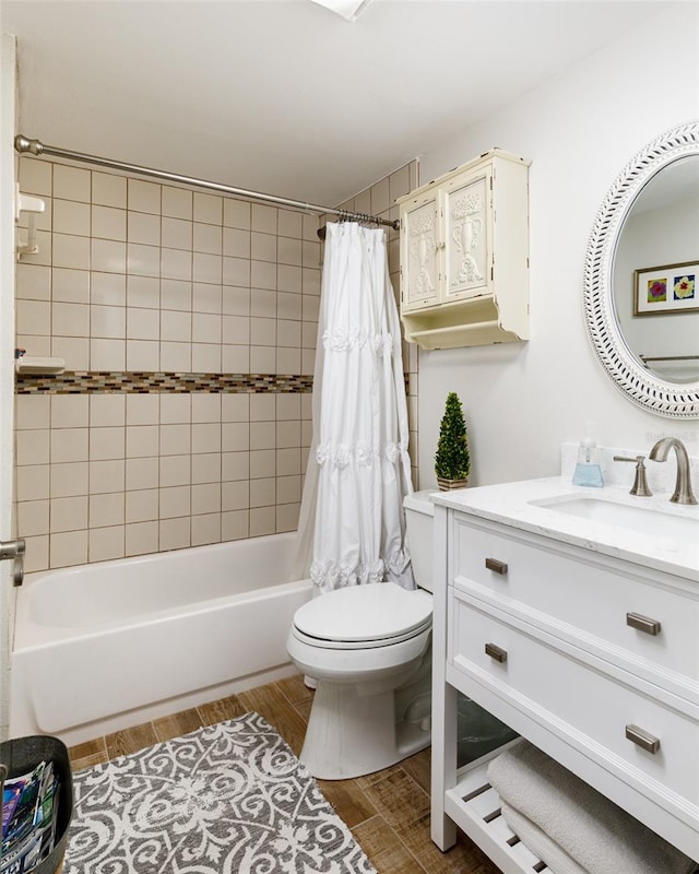 full bathroom with hardwood / wood-style flooring, vanity, shower / bath combo, and toilet