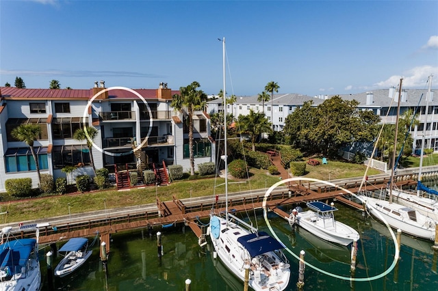 dock area with a water view and a lawn