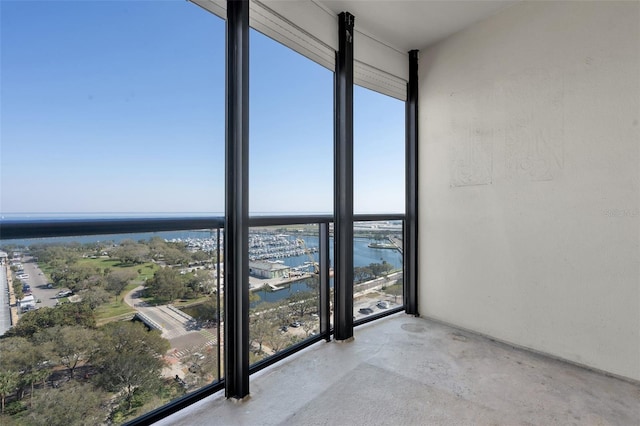 unfurnished sunroom featuring a water view