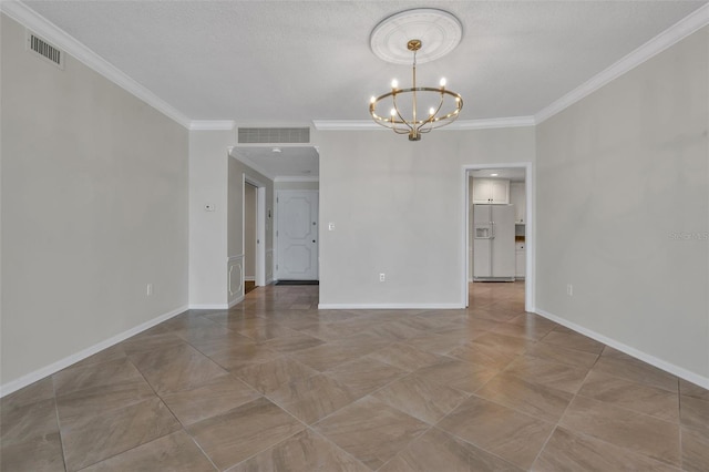 unfurnished room featuring a textured ceiling, ornamental molding, tile floors, and a chandelier