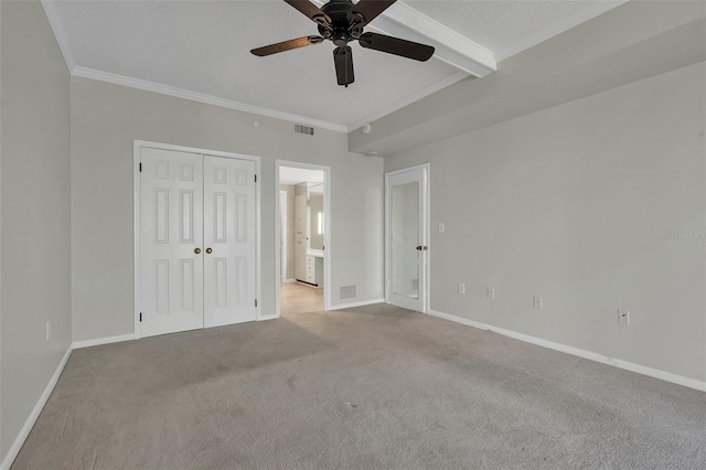 unfurnished bedroom with a closet, beam ceiling, ceiling fan, and light colored carpet