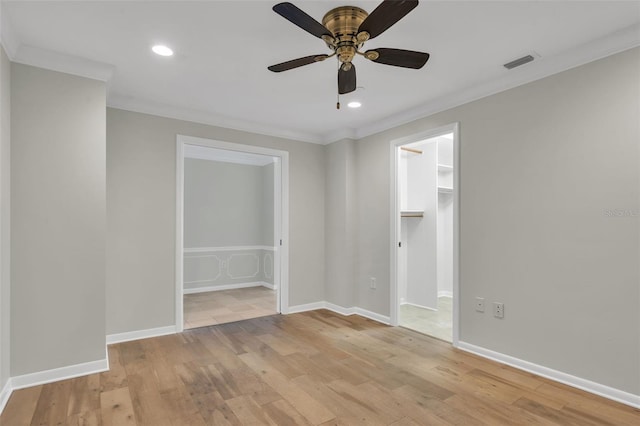 unfurnished room featuring crown molding, ceiling fan, and light wood-type flooring