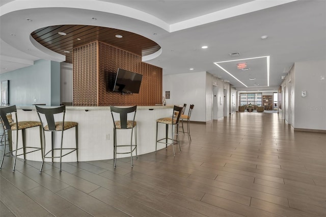 kitchen featuring a breakfast bar and dark hardwood / wood-style flooring