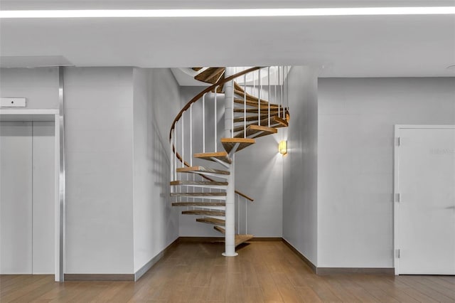 stairway featuring light hardwood / wood-style floors and elevator