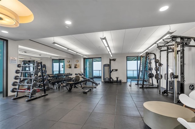 gym featuring dark tile floors