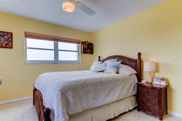 tiled bedroom featuring a textured ceiling and ceiling fan