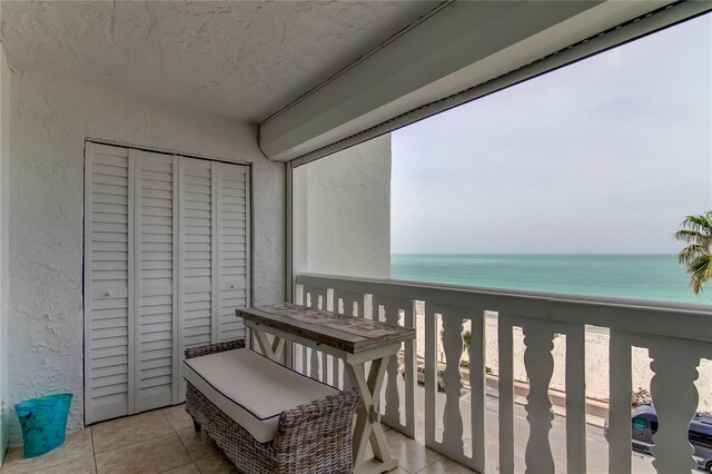 balcony with a water view and a beach view