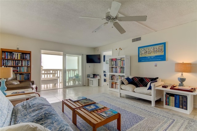 tiled living room featuring a textured ceiling