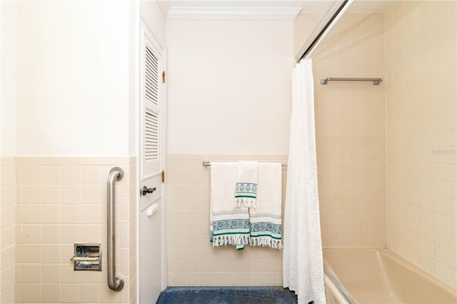 bathroom featuring shower / bath combo with shower curtain, tile walls, and ornamental molding