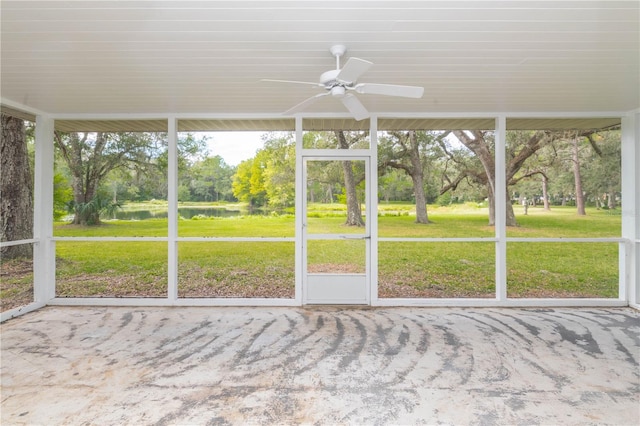 unfurnished sunroom with ceiling fan