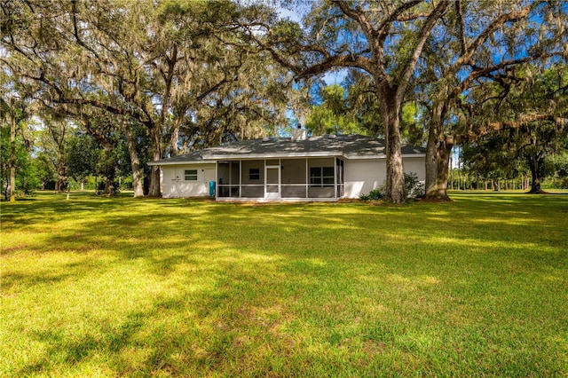 rear view of property with a lawn