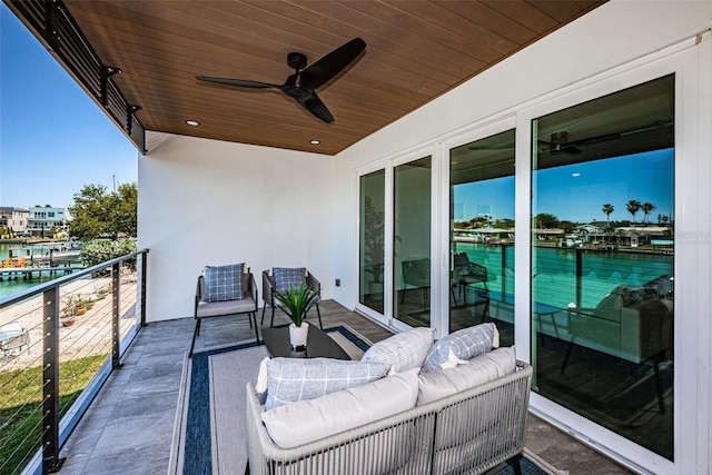 balcony with an outdoor living space and ceiling fan